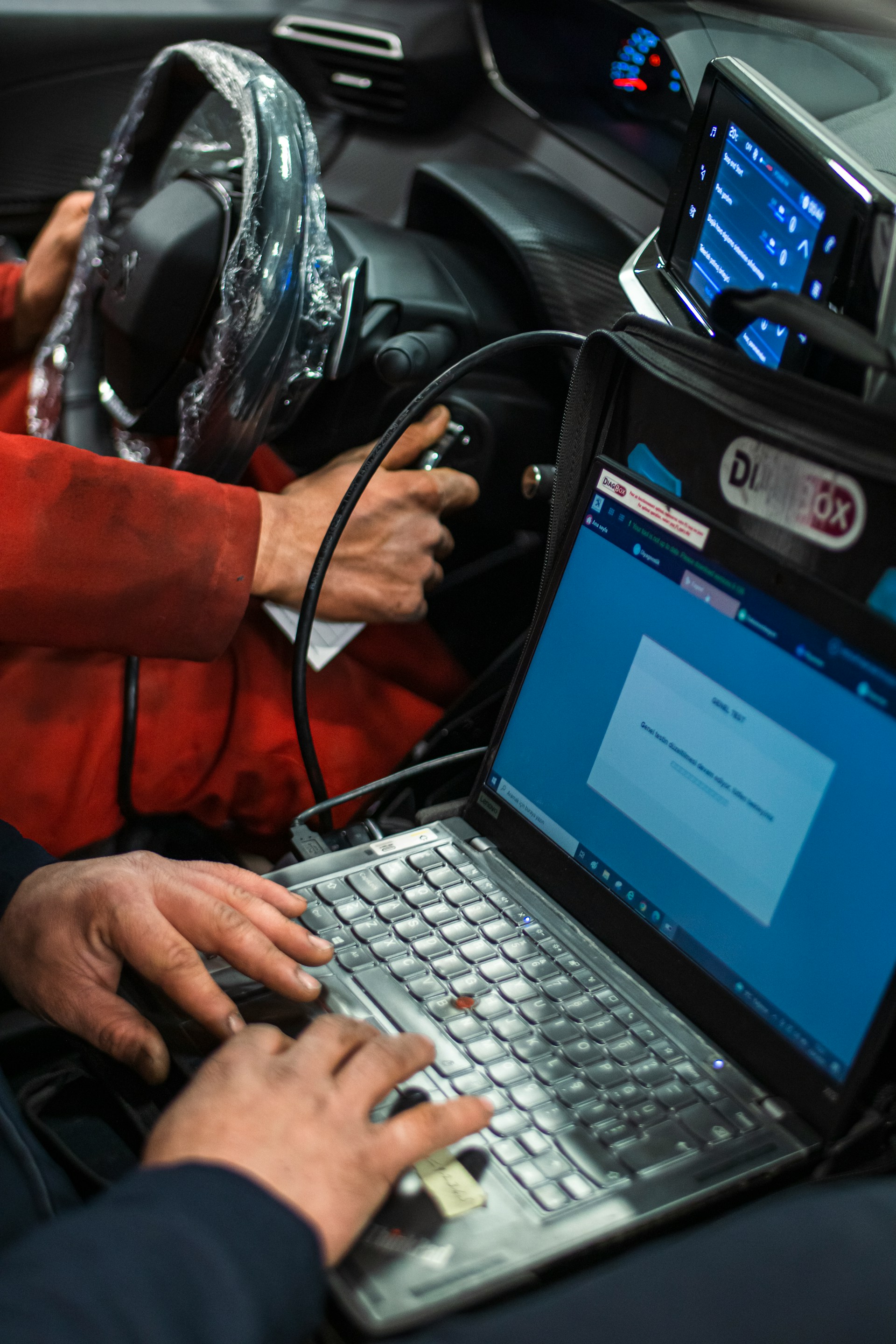 car service workers testing a cars softwares